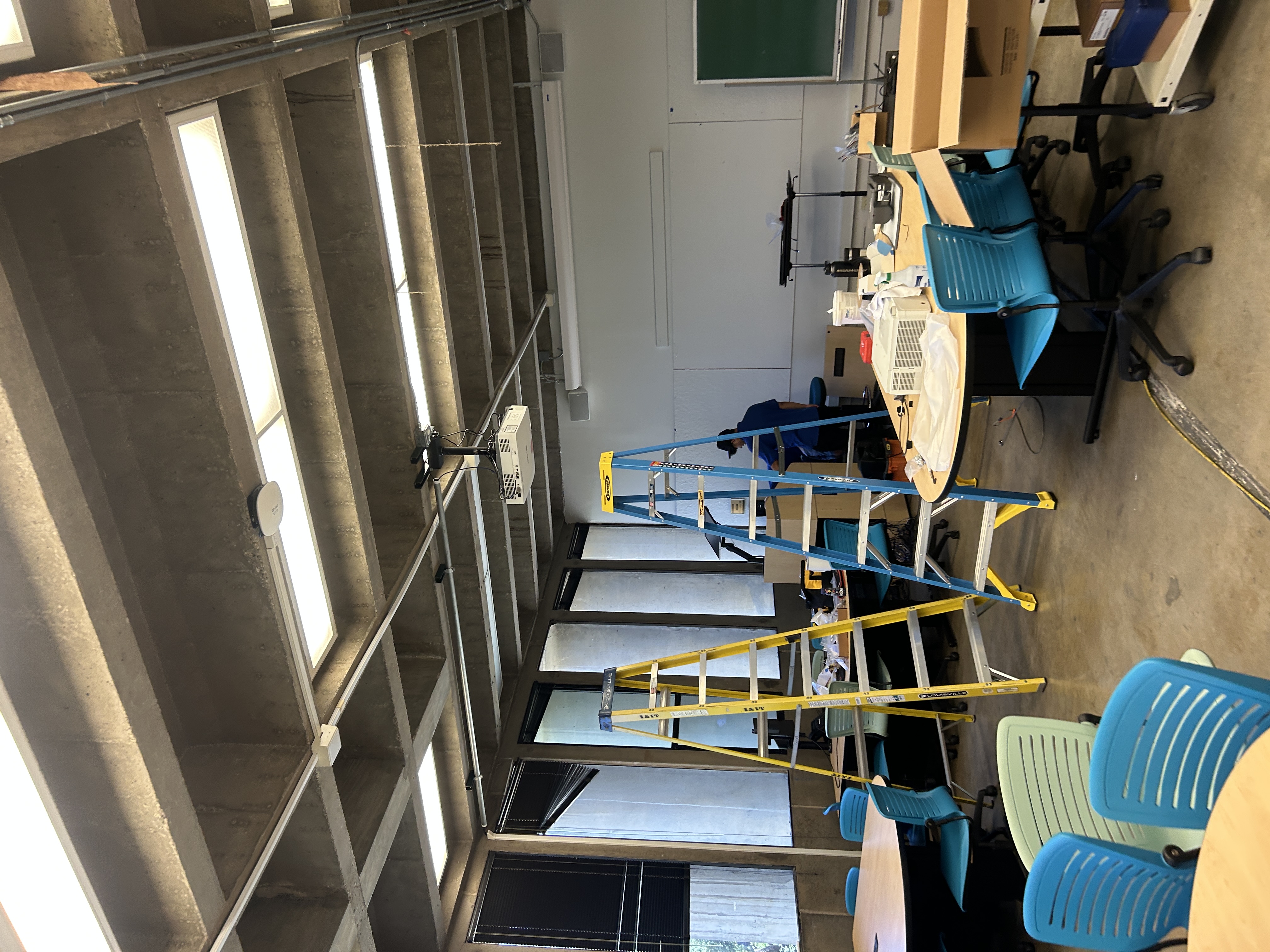 A laptop and installation tools being used during classroom technology field work